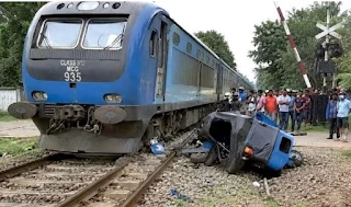signal-lights-are-on-the-train-appears-to-be-coming-and-the-tricycle-is-left-at-the-crossing
