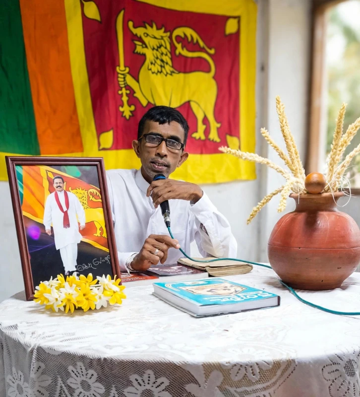 former-pohottuwa-mp-gratian-wears-a-robe-and-carries-a-naga-bag-on-a-new-march